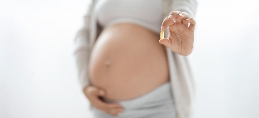 Pregnant woman holding prenatal vitamin capsule – BirthRight by Rainbow Hospitals