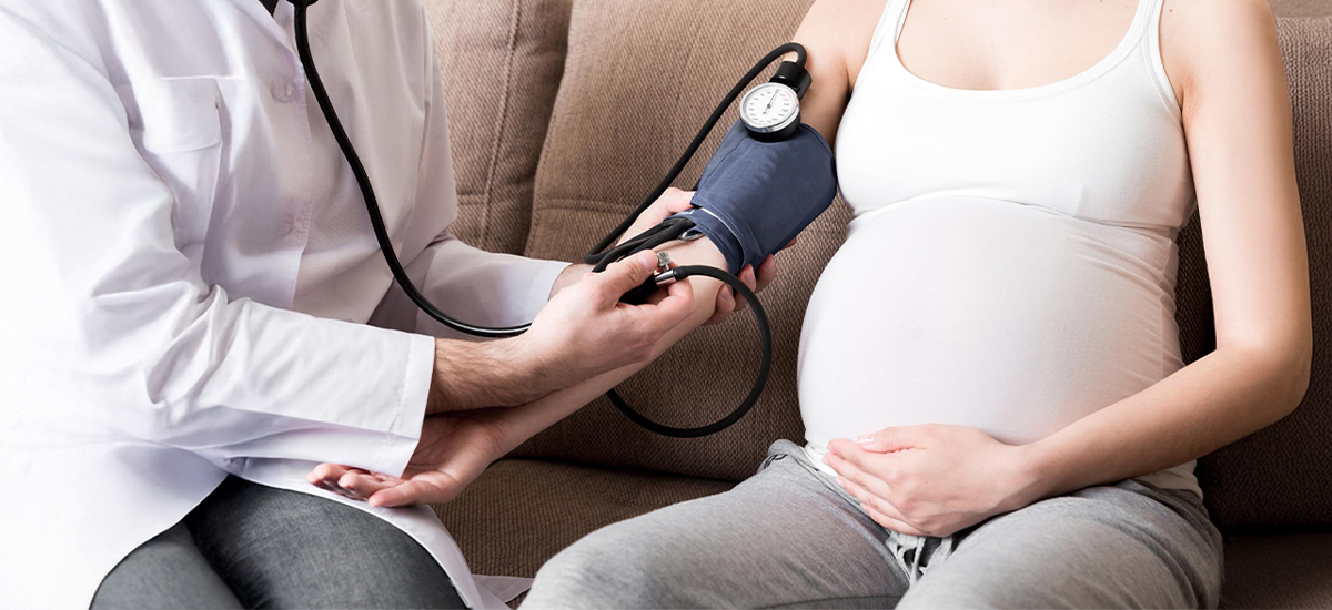 Doctor checking blood pressure of pregnant woman during prenatal care – BirthRight by Rainbow Hospitals