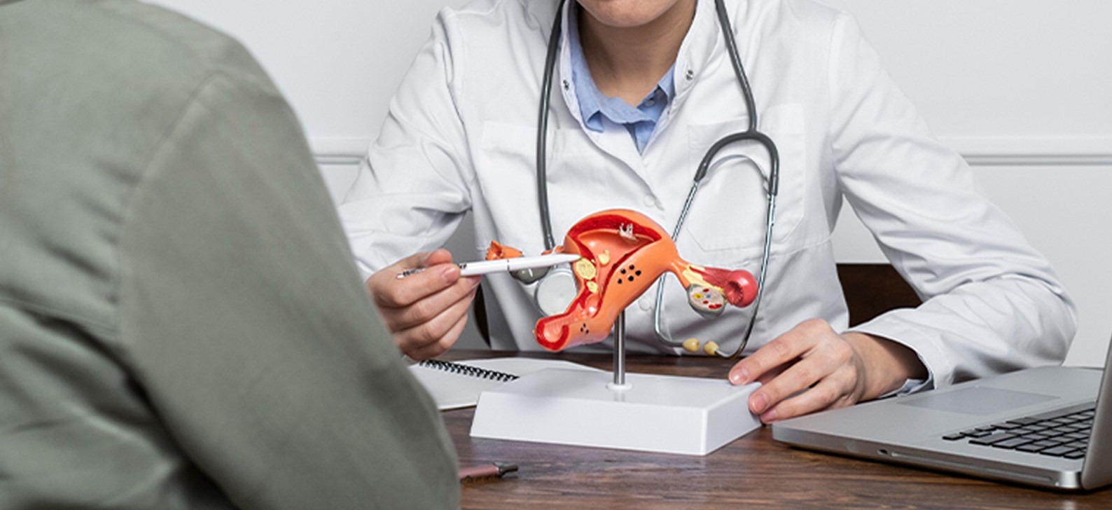 Gynecologist explaining female reproductive system model to a patient at Rainbow Children’s Hospital