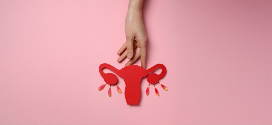 Hand holding a red uterus model symbolizing Bilateral PCOD and women’s reproductive health