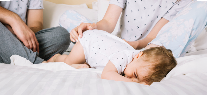 Child holding stomach in discomfort due to digestive problems – Rainbow Children’s Hospitals