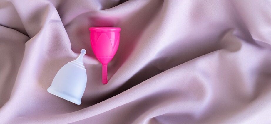 Two menstrual cups placed on soft fabric, representing safe and eco-friendly period care
